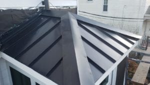 Standing-seam metal roof replacement.